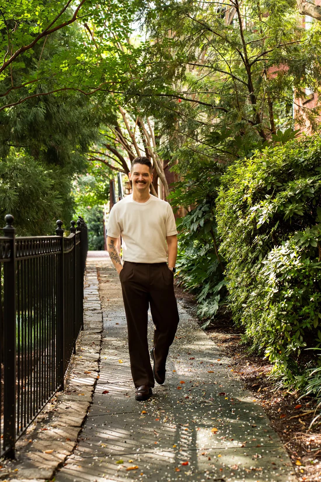Cory Klose walking a tree-lined intown Atlanta sidewalk
